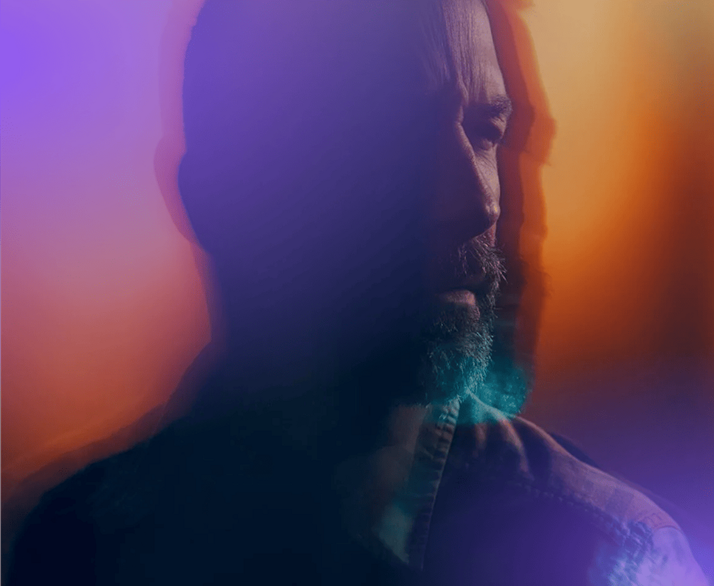 Man looking ahead through a purple-orange haze