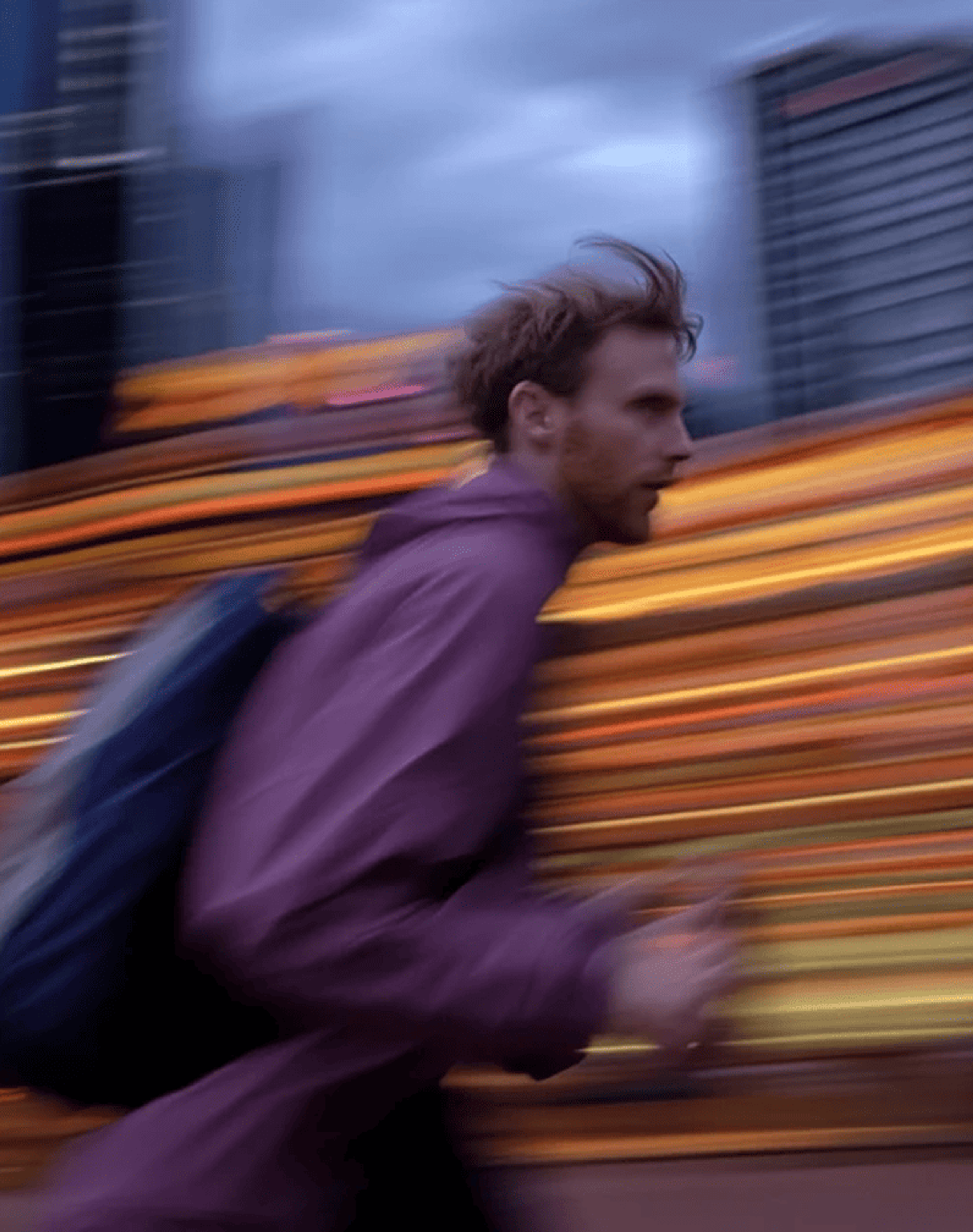 Man running against a blurred city backdrop