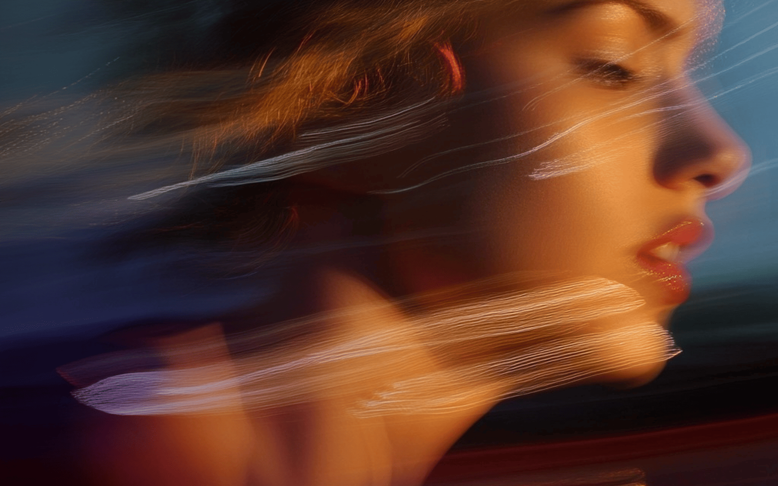 Woman's face in motion blur with streaks of light and warm tones