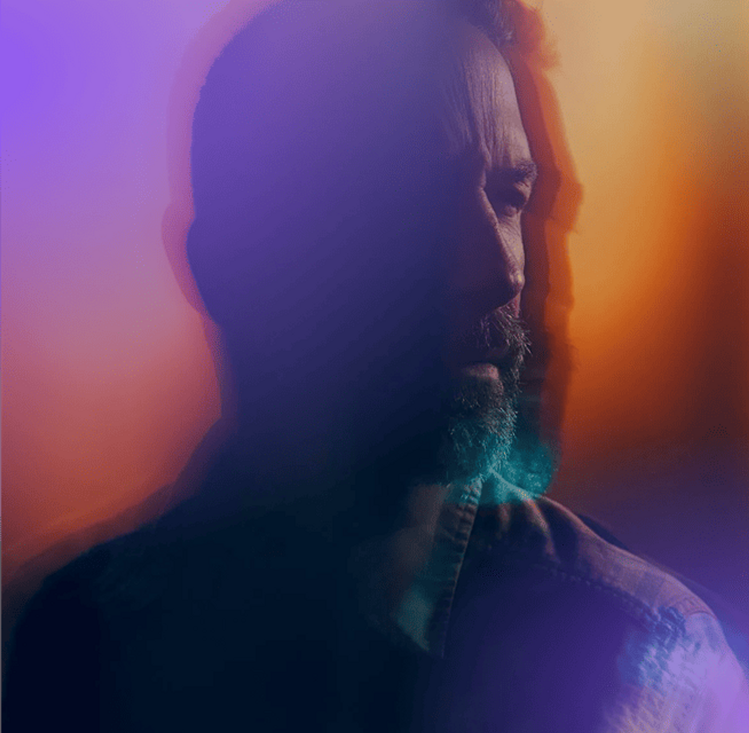 Man looking ahead through a purple-orange haze