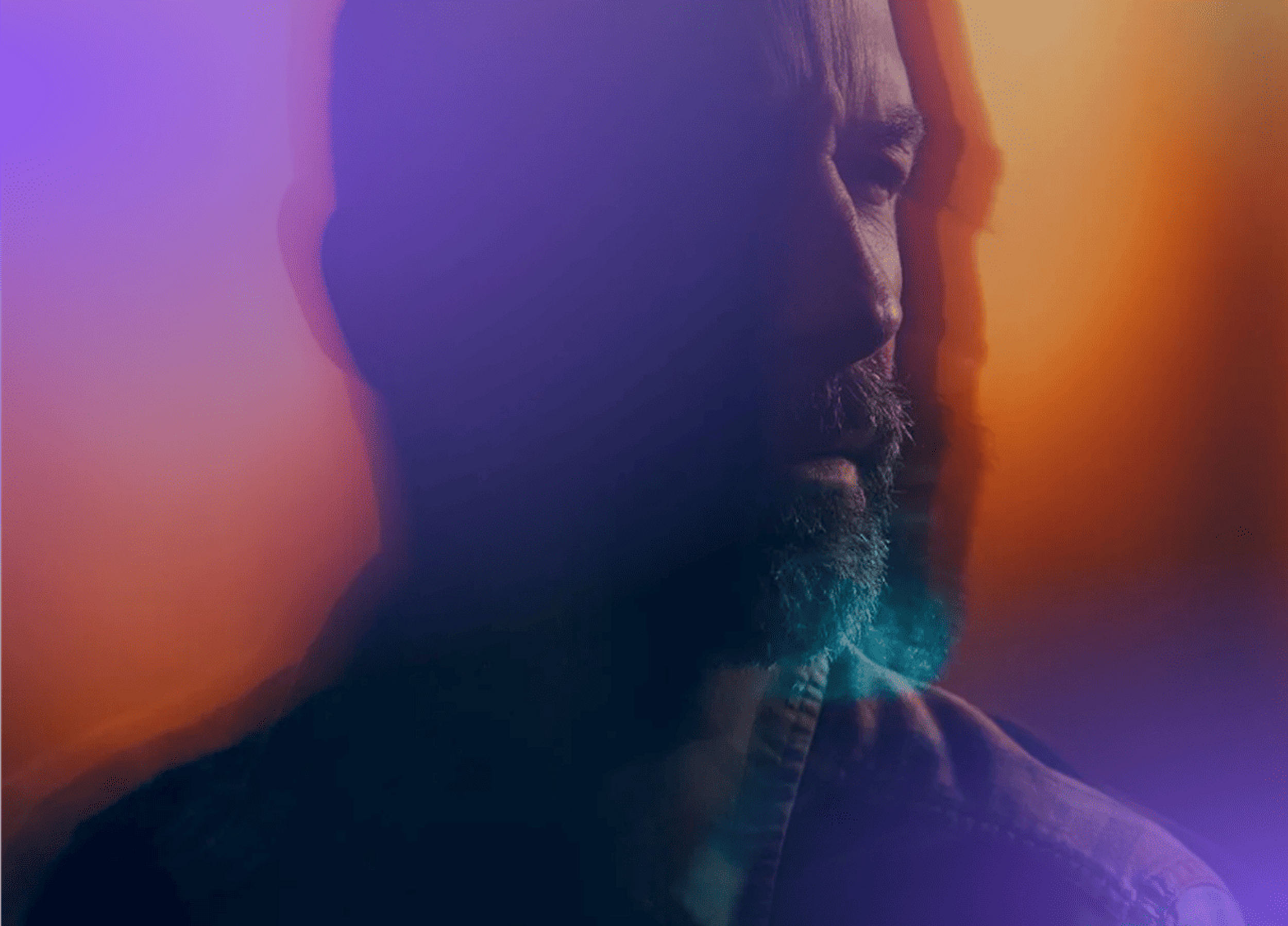 Man looking ahead through a purple-orange haze