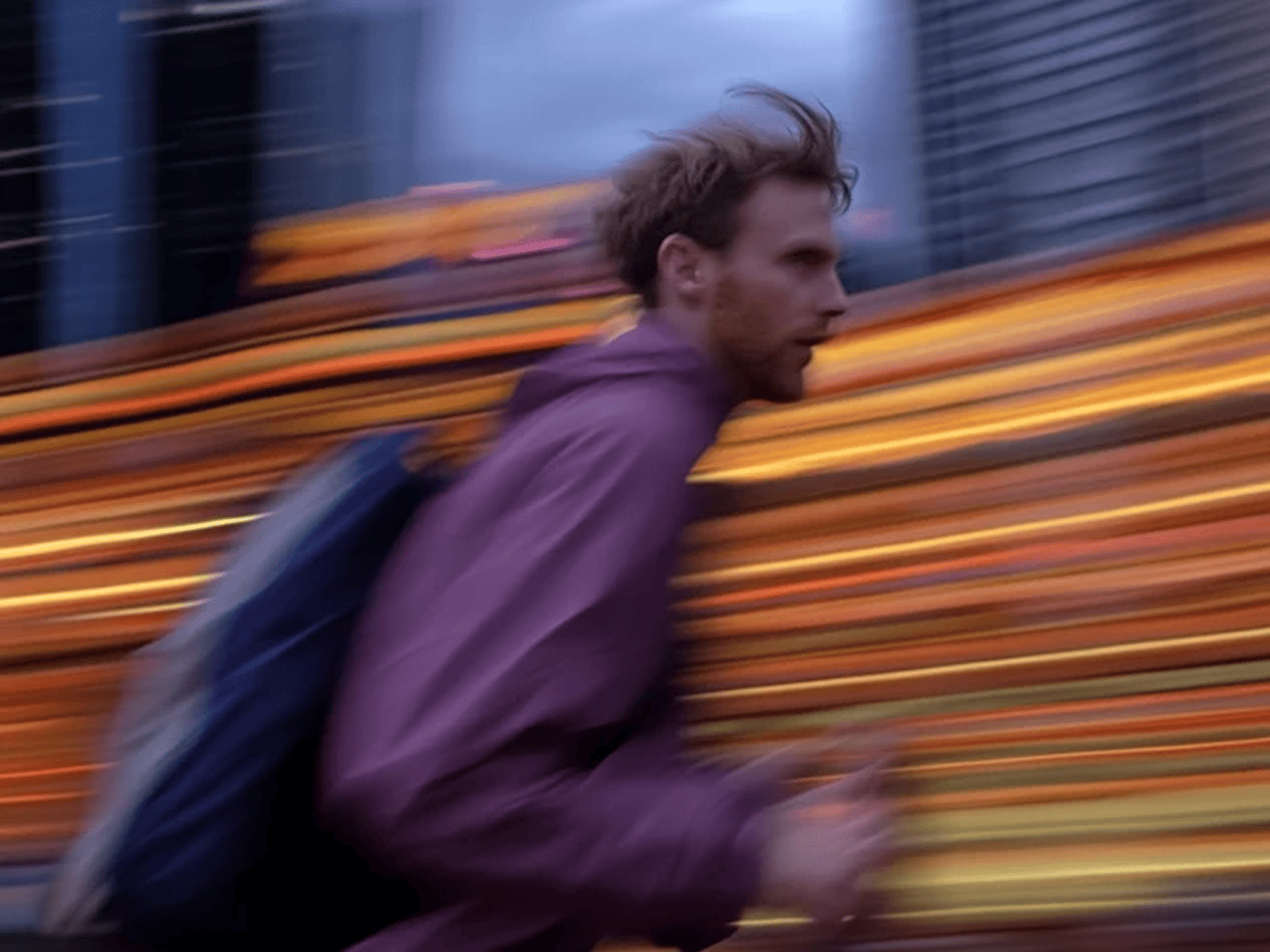 Man running against a blurred city backdrop