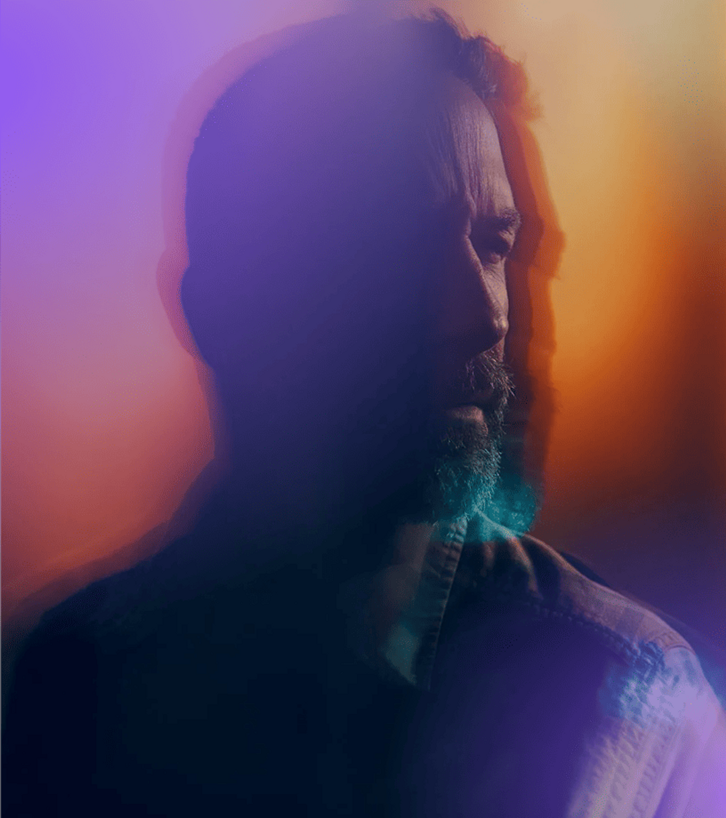 Man looking ahead through a purple-orange haze