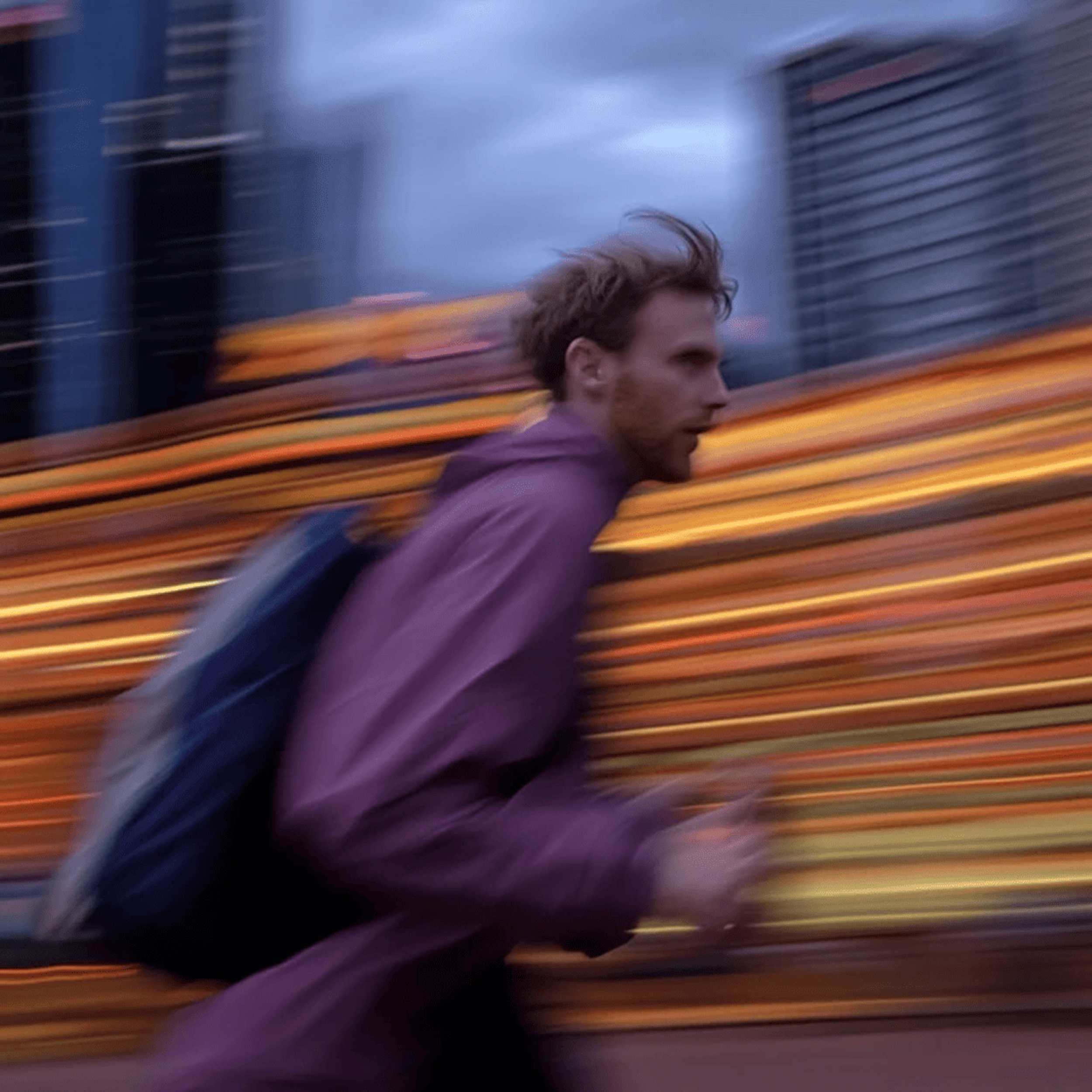 Man running against a blurred city backdrop